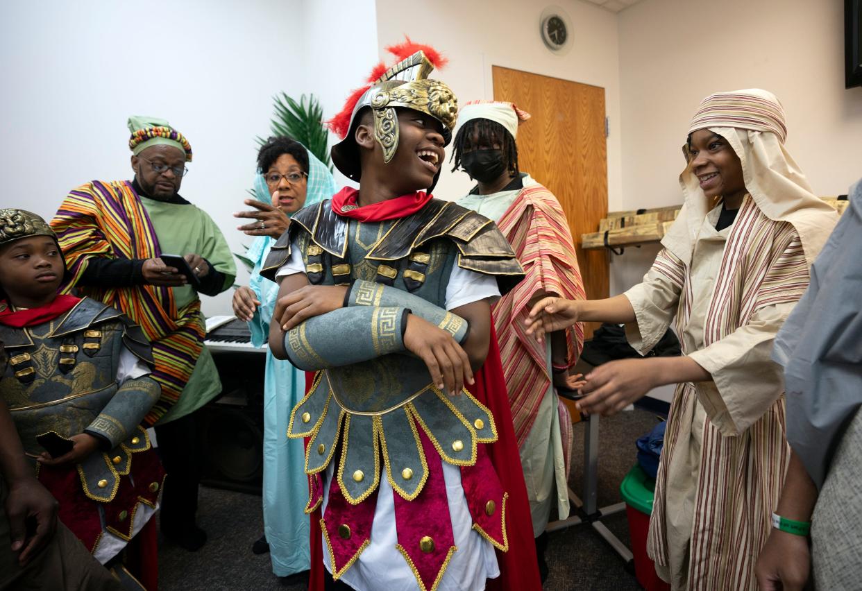 Sincere Ingram, dressed as a soldier, laughs with other performers prior to a special Easter performance at the Family Missionary Baptist Church.