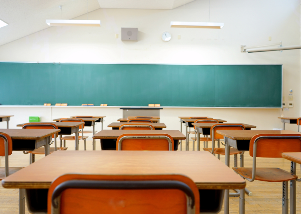 An empty classroom as viewed from the back.