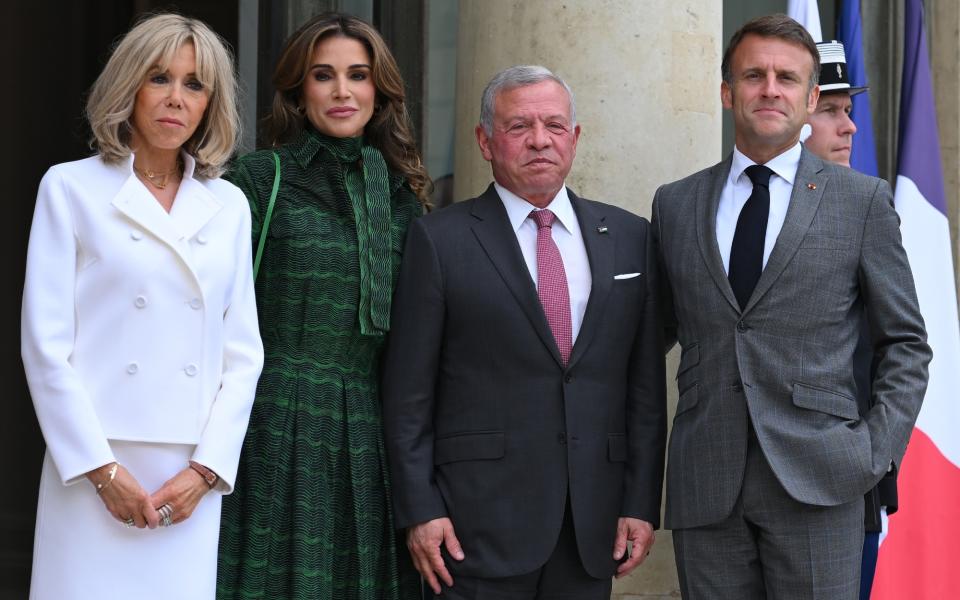 PARIS, FRANCE - JUNE 24 Jordan's King Abdallah II (2ndR) is welcomed by France's President Emmanuel Macron (R) as Jordan's Queen Rania (3rdR) and French first lady Brigitte Macron (C) look at Elysee Palace on June 24, 2024 in Paris, France. (Photo by Christian Liewig - Corbis/Corbis via Getty Images)