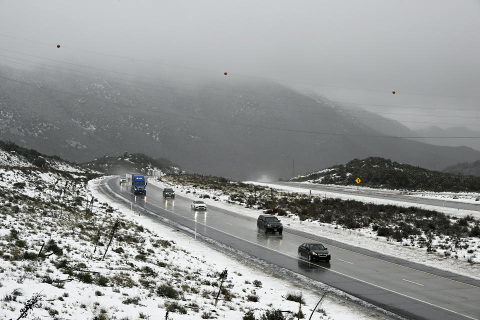 Westbound traffic moves on the I-8 at the Laguna Summit in Wednesday, Feb. 7, 2024, in eastern San Diego County, Calif. According to the National Weather Service snow level is down to 4500 feet in the San Diego County mountains. (AP Photo/Denis Poroy)