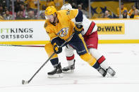 Nashville Predators center Ryan Johansen (92) gets past Carolina Hurricanes defenseman Brady Skjei (76) as Johansen scores in the second period of an NHL hockey game Saturday, Oct. 16, 2021, in Nashville, Tenn. (AP Photo/Mark Humphrey)