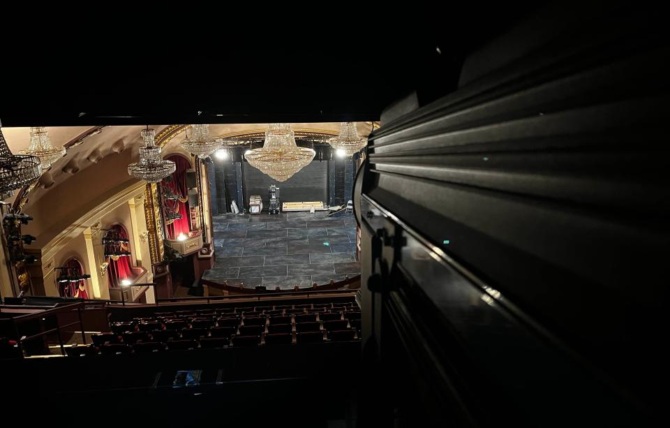 A spotlight points toward the stage at the Historic Cocoa Village Playhouse. It sits above the balcony in an area that was once the projection room when the theater was a film house. It is this room where Joe the caretaker's presence is greatly connected to.