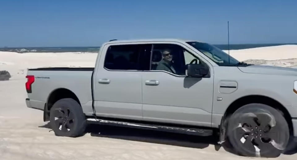 Kevin De Bruin smiling behind the wheel of his EV 4WD F-150.