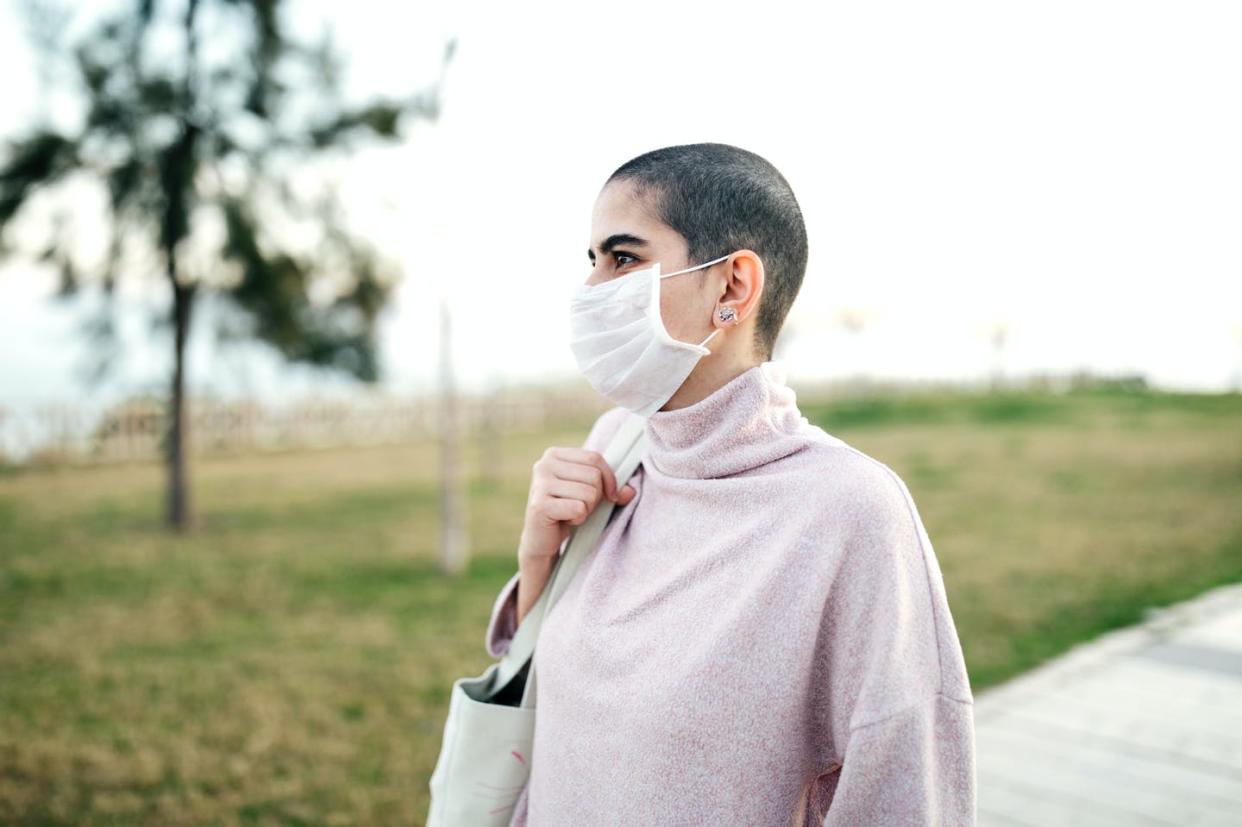 <span class="caption">Cancer and organ transplant patients, people with untreated HIV and people with other immunodeficiencies are at high risk of severe COVID-19 infection.</span> <span class="attribution"><a class="link " href="https://www.gettyimages.com/detail/photo/woman-wearing-mask-to-avoid-infectious-diseases-royalty-free-image/1216044531" rel="nofollow noopener" target="_blank" data-ylk="slk:burakkarademir/E+ via Getty Images;elm:context_link;itc:0;sec:content-canvas">burakkarademir/E+ via Getty Images</a></span>