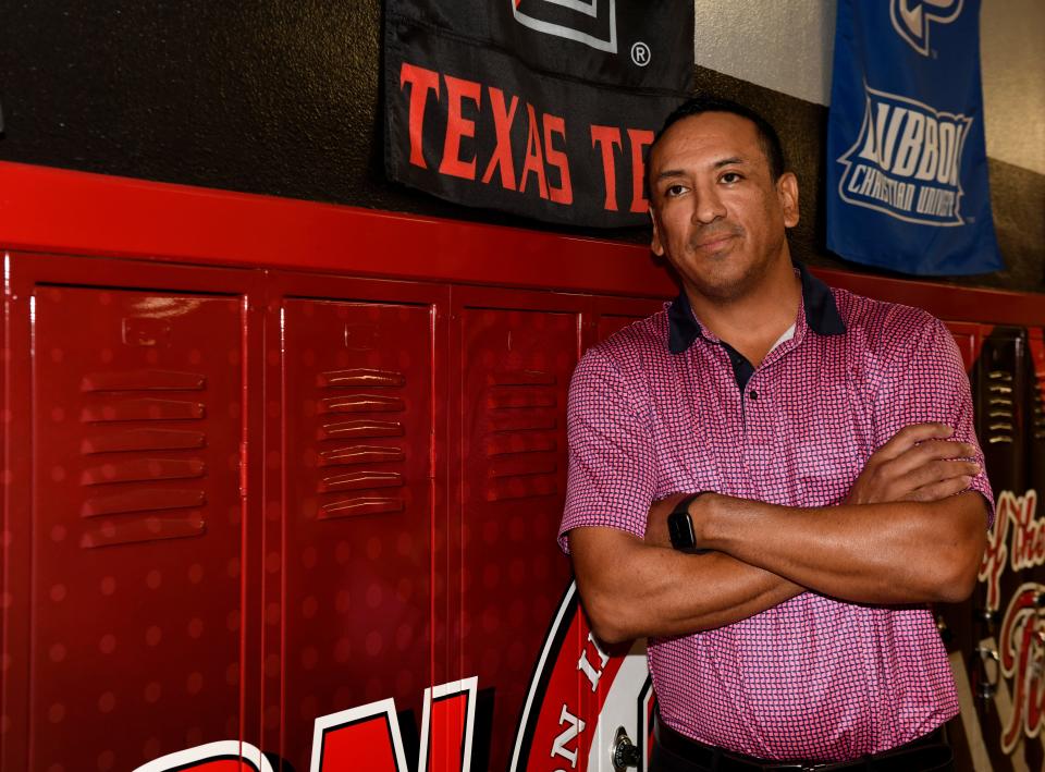 Former Texas Tech basketball player and current Slaton High School principal Jesus Arenas stands in front of school lockers, Thursday, Sept. 7, 2023, at Slaton High School in Slaton.
