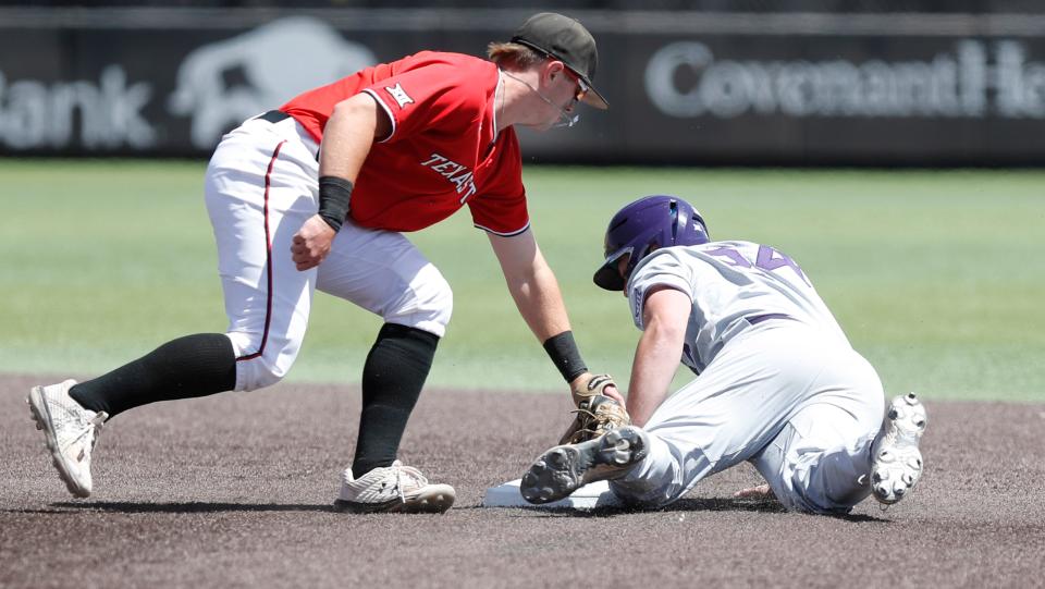 Tech’s Josh Jung (2) attempts tag out Dylan Phillips (24) during a Big 12 Conference contest Saturday, April 9, 2022 at Dan Law Field at Rip Griffin Park. [Mark Rogers/For the Avalanche-Journal]