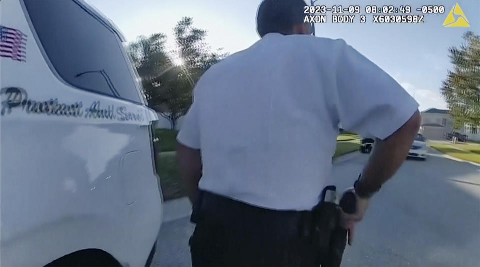 This screen grab taken from Hillsborough County police body cam video shows Hillsborough County deputies looking at an oncoming vehicle on Thursday, Nov. 9, 2023 in Brandon, Fla. A man intentionally drove into two sheriff's deputies on Thursday, badly injuring them before a third deputy arrested him, authorities said. (Hillsborough County Sheriff's Department via AP)