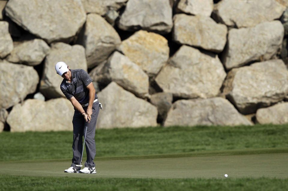 Rory McIlroy of Northern Ireland plays a ball on the 12th hole during the 3rd round of the Abu Dhabi HSBC Golf Championship in Abu Dhabi, United Arab Emirates, Saturday Jan. 18, 2014. (AP Photo/Kamran Jebreili)