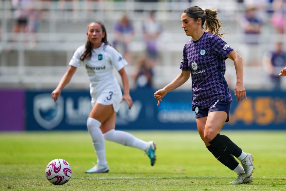 Racing Louisville FC midfielder Savannah DeMelo (7) controls the ball during a match against New Jersey/New York Gotham FC at Lynn Family Stadium on June 18, 2023.