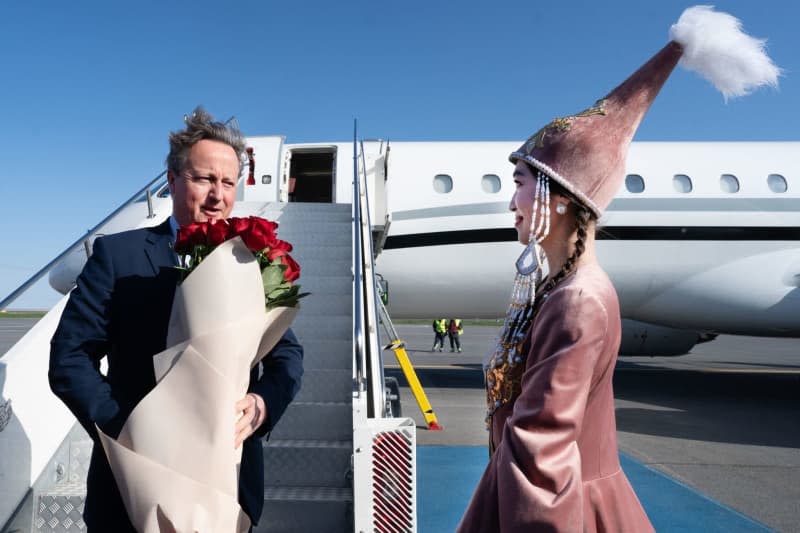 UK Foreign Secretary David Cameron (L) arrives at Nur Sultan/Astana Airport, in Kazakhstan. Stefan Rousseau/PA Wire/dpa