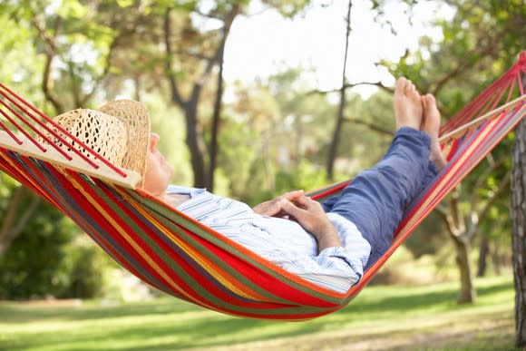 A person relaxing in a hammock.