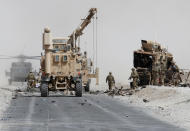 <p>U.S. troops assess the damage to an armoured vehicle of NATO-led military coalition after a suicide attack in Kandahar province, Afghanistan Aug. 2, 2017. (Photo: Ahmad Nadeem/Reuters) </p>