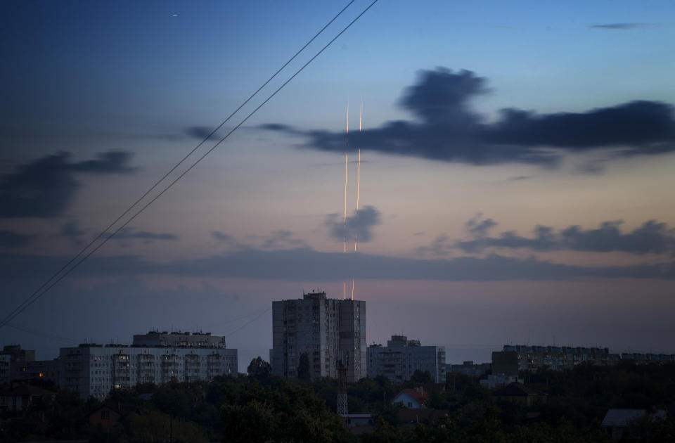 Russian rockets launch against Ukraine from Russia's Belgorod region are seen at dawn in Kharkiv, Ukraine, early Thursday, Aug. 18, 2022. (AP Photo/Vadim Belikov)