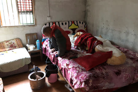 Wang Zhaohong, who suffers from silicosis, is seen on his bed in Sangzhi county, Hunan province, China November 27, 2018. Picture taken November 27, 2018. REUTERS/Sue-Lin Wong