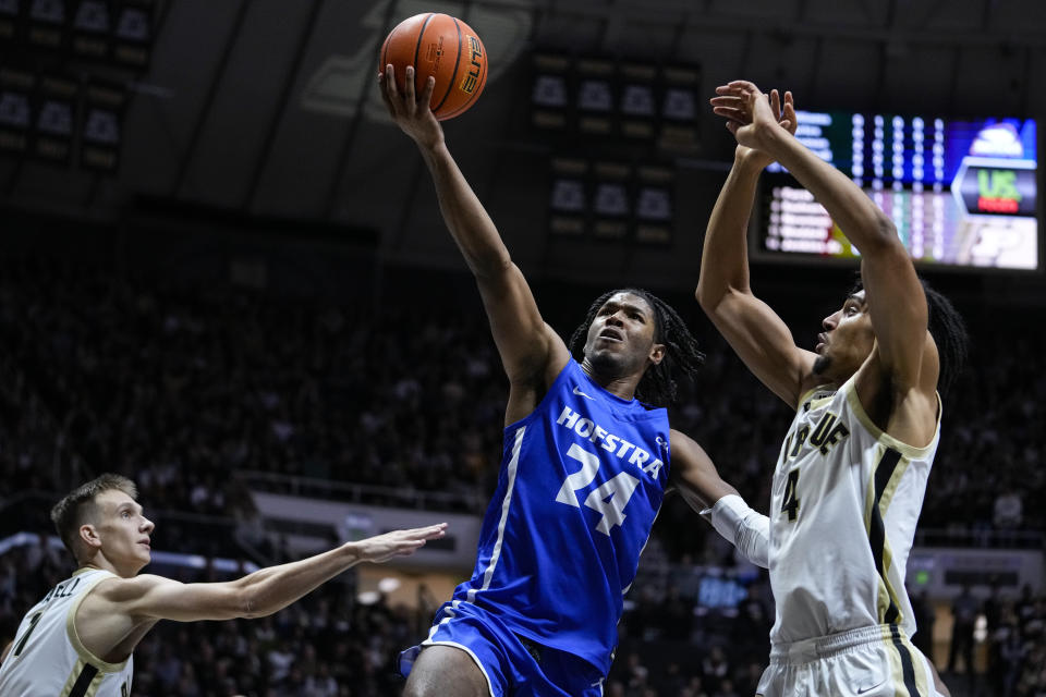 Hofstra guard Amar'e Marshall (24) shoots between Purdue forward Caleb Furst (1) and forward Trey Kaufman-Renn (4) during the first half of an NCAA college basketball game in West Lafayette, Ind., Wednesday, Dec. 7, 2022. (AP Photo/Michael Conroy)