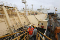 In this Friday, Dec. 7, 2018 photo, workers board large-sized liquefied natural gas (LNG) carriers under construction at the Daewoo Shipbuilding and Marine Engineering facility in Geoje Island, South Korea. South Korea’s big three shipbuilders _ Daewoo, Hyundai Heavy Industries and Samsung Heavy Industries _ won orders for 53 new LNG carriers in 2018 at about $200 million each, soaking up the lion’s share of the 62 vessels ordered globally, according to numbers compiled by the London-based shipping group Clarkson Research. (AP Photo/Ahn Young-joon)