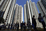 People line up to vote outside of a polling place in Hong Kong, Sunday, Nov. 24, 2019. Long lines formed outside Hong Kong polling stations Sunday in elections that have become a barometer of public support for anti-government protests now in their sixth month. (AP Photo/Vincent Yu)