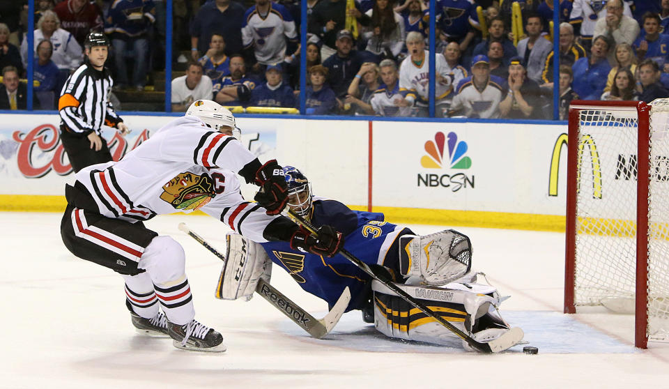 Chicago Blackhawks center Jonathan Toews (left) scores the game-winning goal in overtime past St. Louis Blues goaltender Ryan Miller during Game 5 of a Western Conference quarterfinal playoff game Friday, April 25, 2014, at the Scottrade Center in St. Louis. (AP Photo/The St. Louis Post-Dispatch, Chris Lee)