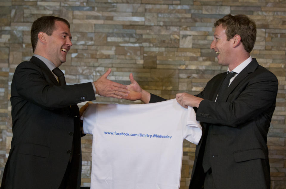 Russian Prime Minister Dmitry Medvedev, left, shakes hands with Facebook CEO Mark Zuckerberg at the Gorki residence outside Moscow, Russia, Monday, Oct. 1, 2012. Zuckerberg presented Medvedev with a T-shirt bearing his Facebook address. (AP Photo/Alexander Zemlianichenko, pool)