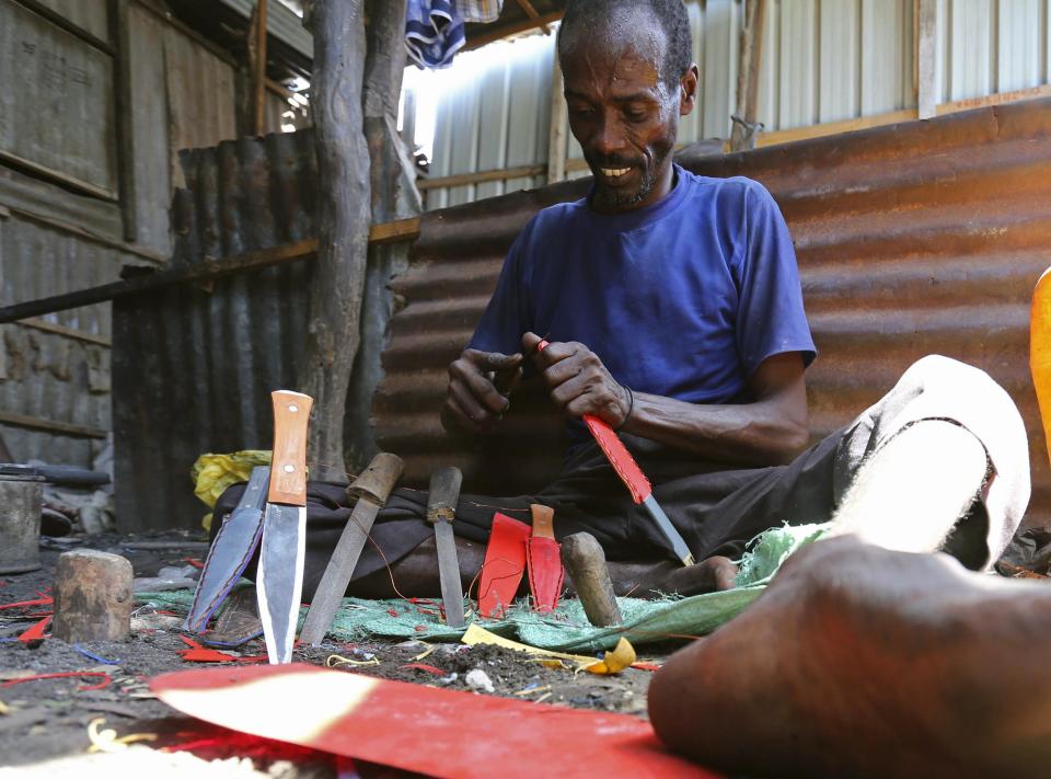 A blacksmith makes knives at his workshop, for sale to customers in Somalia's capital Mogadishu