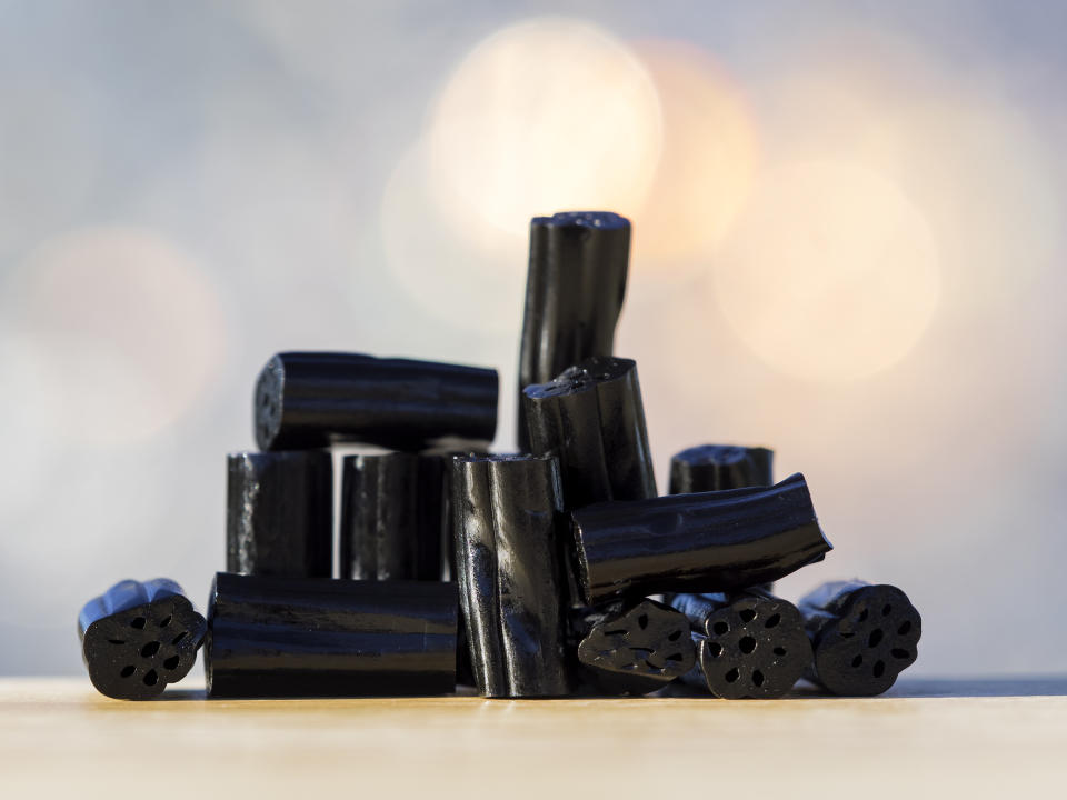 Heap of soft candies of licorice on a table, illuminated by the light of the Sun