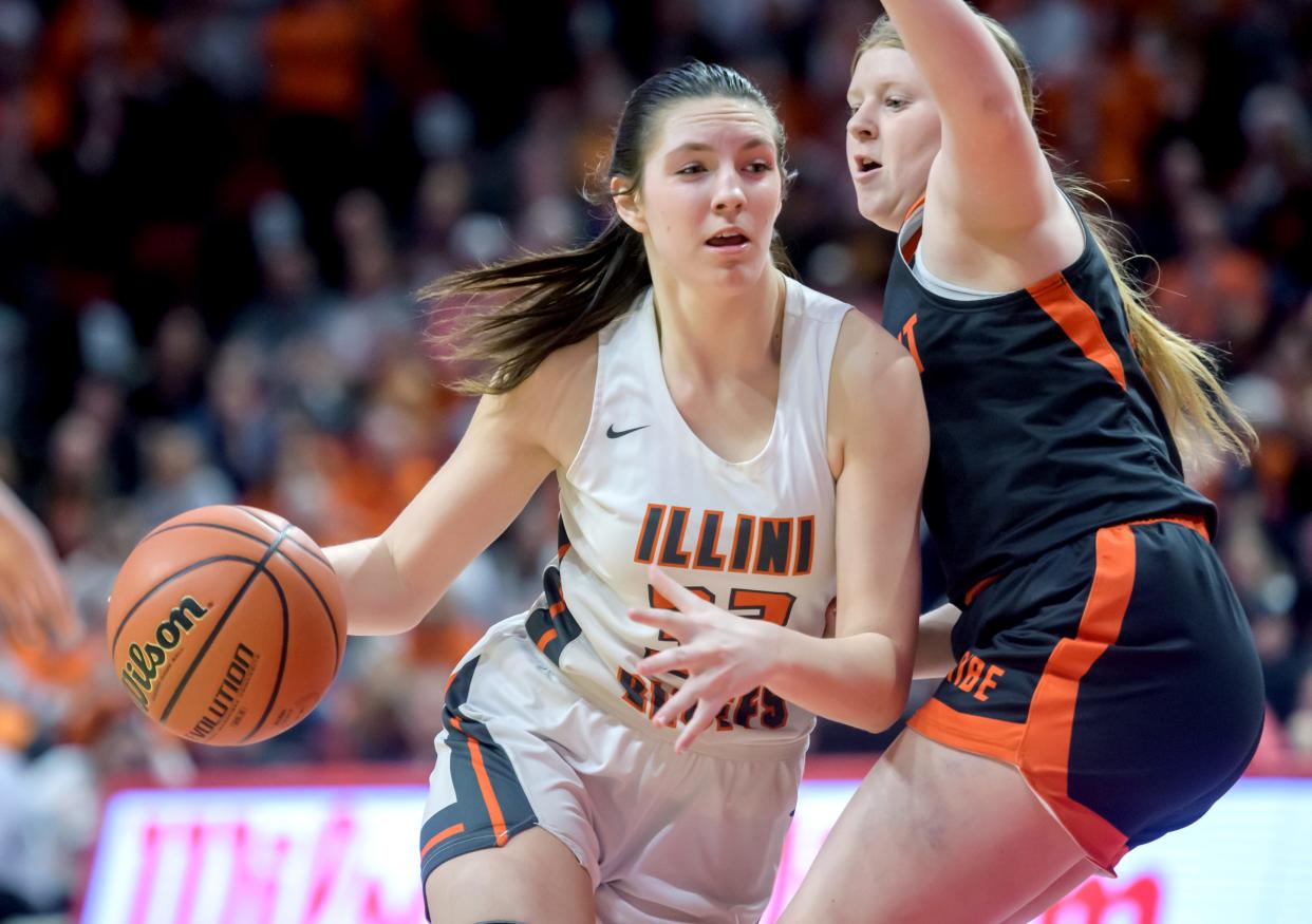 Illini Bluffs' Lily Luczkowiak, left, moves the ball against Altamont's Libby Reardon in the second half of their Class 1A girls basketball state semifinal Thursday, Feb. 29, 2024 at CEFCU Arena in Normal. The Tigers defeated the Lady Indians 60-48 in overtime.