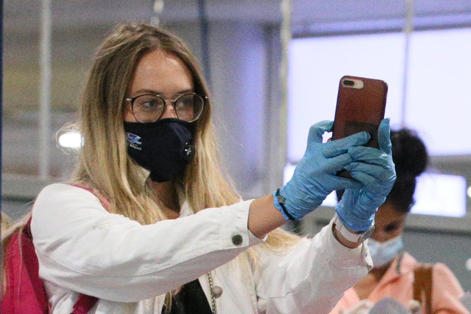 MOSCOW REGION, RUSSIA  JULY 20, 2020: A Russian traveller in a face mask in the arrivals hall at the Sheremetyevo International Airport after arriving on a Royal Flight Airlines charter flight from Dar es Salaam, Tanzania, during the pandemic of the novel coronavirus disease (COVID-19). The repatriation flight took 130 Russian evacuees from six African countries (Tanzania, Kenya, Mali, Sudan, South Sudan and Ethiopia) to Moscow. Since 27 March 2020, Russia suspended all international flights with the exception of evacuation flights, to counter the spread of coronavirus. Vladimir Gerdo/TASS (Photo by Vladimir Gerdo\TASS via Getty Images)