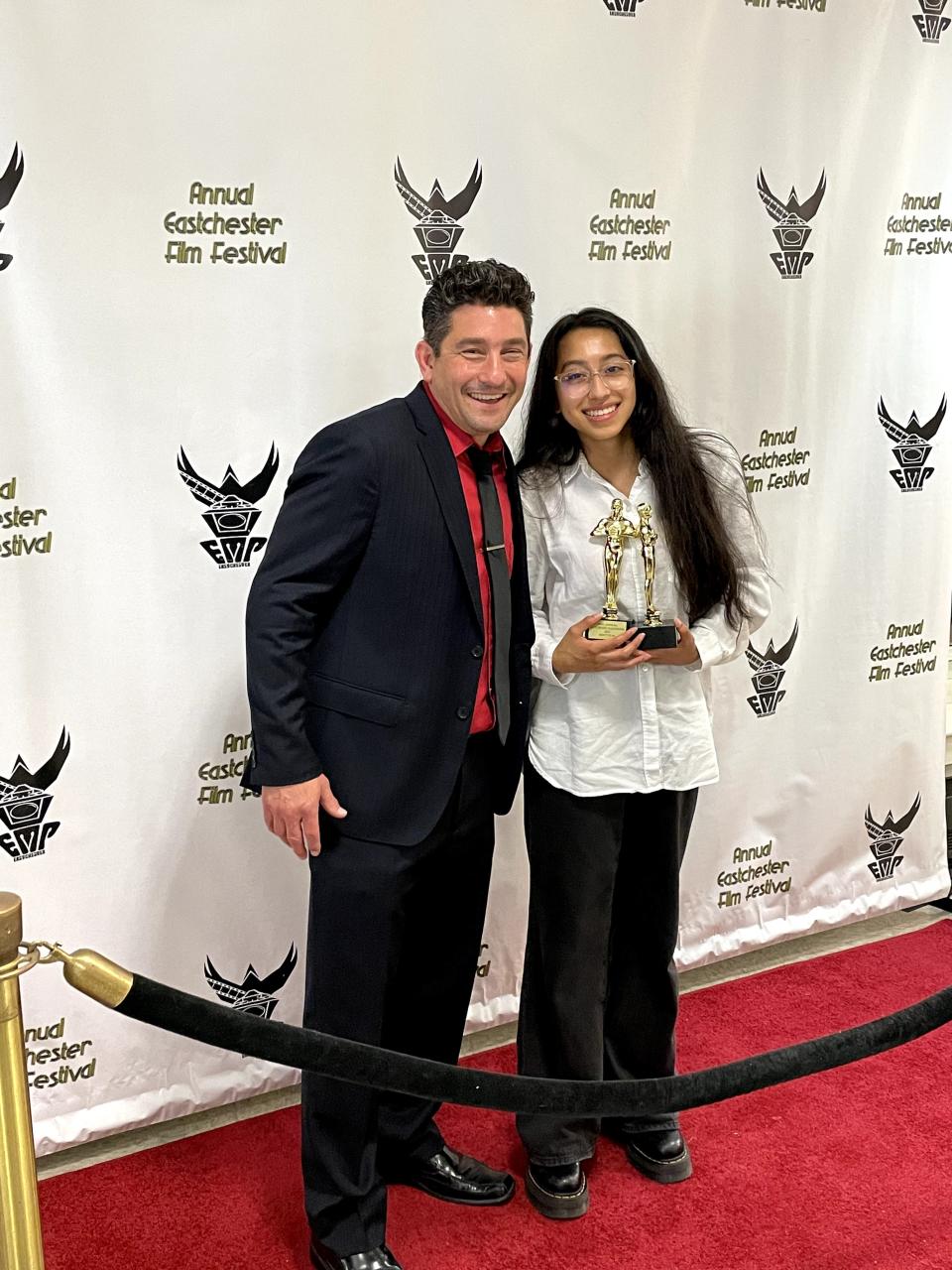 Valentina Quintero, right, with two awards (for Best Film and Best Story) at the 2022 Eastchester High School Film Festival. She is pictured with Michael Goldstein, an Eastchester High School Film Teacher. Quintero is a senior at Eastchester High School pursuing a film production degree in college.