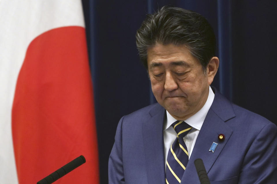 FILE - In this March 28, 2020, file, photo, Japanese Prime Minister Shinzo Abe bites his lips during his speech about the coronavirus situation in Japan at the prime minister's official residence in Tokyo. Before the Olympics were postponed, Japan looked like it had coronavirus infections contained, even as they spread in neighboring countries. Now that the games have been pushed to next year, Tokyo’s cases are spiking, and the city's governor is requesting that people stay home, even hinting at a possible lockdown. (AP Photo/Eugene Hoshiko, File)