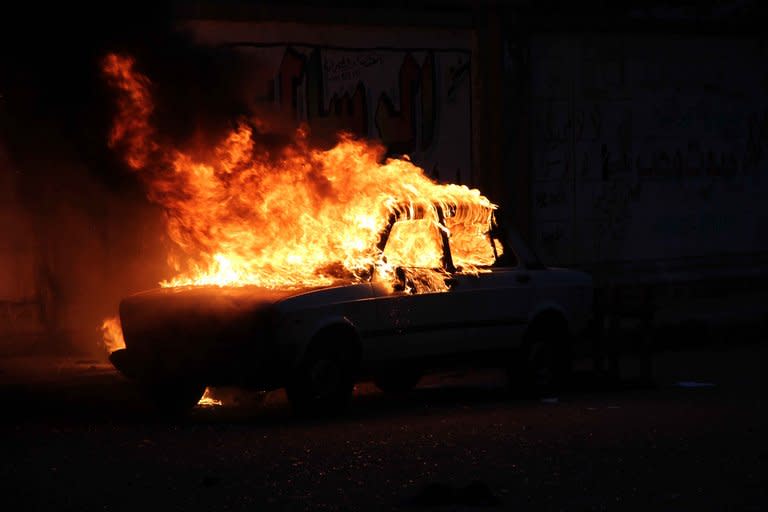 A car burns during clashes between supporters and opponents of Egyptian President Mohamed Morsi outside Cairo University on July 3, 2013. Egypt was on edge Wednesday after President Mohamed Morsi refused to quit hours before an army ultimatum expires, following deadly violence during rival mass protests in Egypt's worst crisis since its 2011 revolution