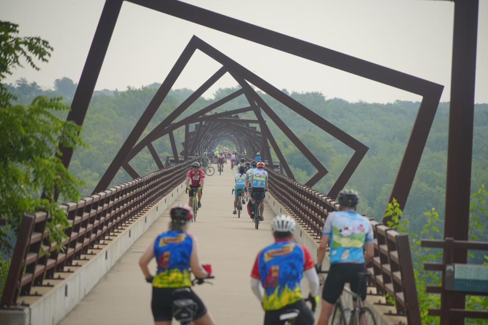 Riders cross the High Trestle Bridge near Madrid as RAGBRAI 50 rolls toward Des Moines on Wednesday, July 26, 2023.