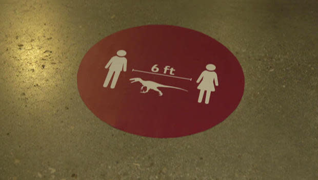 The Natural History Museum of Utah reminds visitors to keep at least one-velociraptor distance apart.  / Credit: CBS News