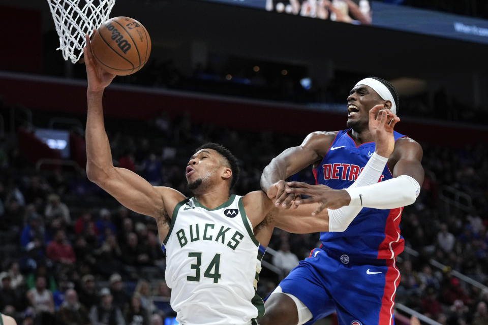 Milwaukee Bucks forward Giannis Antetokounmpo (34) is fouled by Detroit Pistons center Jalen Duren (0) in the second half of an NBA basketball game in Detroit, Monday, Jan. 23, 2023. (AP Photo/Paul Sancya)