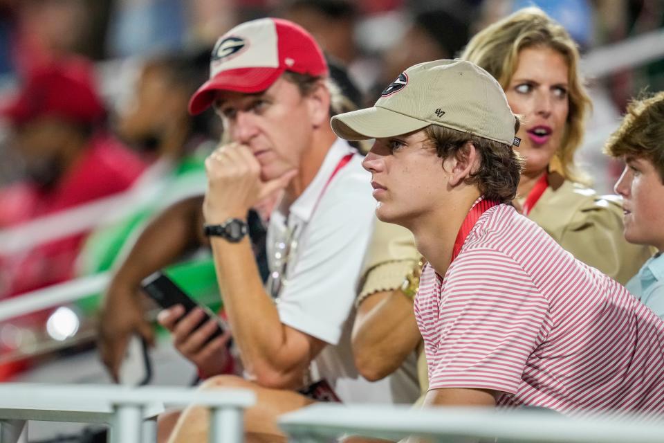 Arch Manning watches Georgia play South Carolina with his parents, Cooper and Ellen.