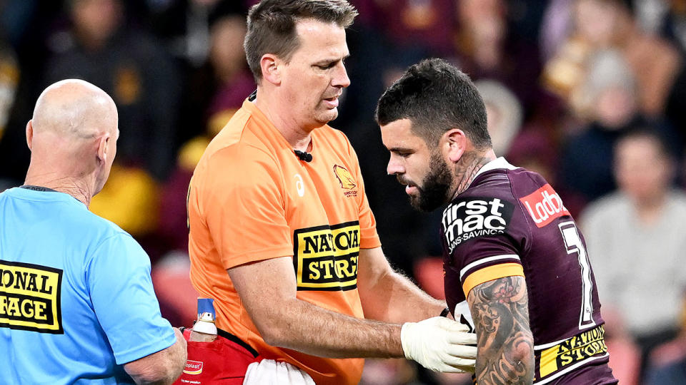 Pictured here, Adam Reynolds is treated for a rib injury in Brisbane's gutsy round 14 win over the Raiders. 