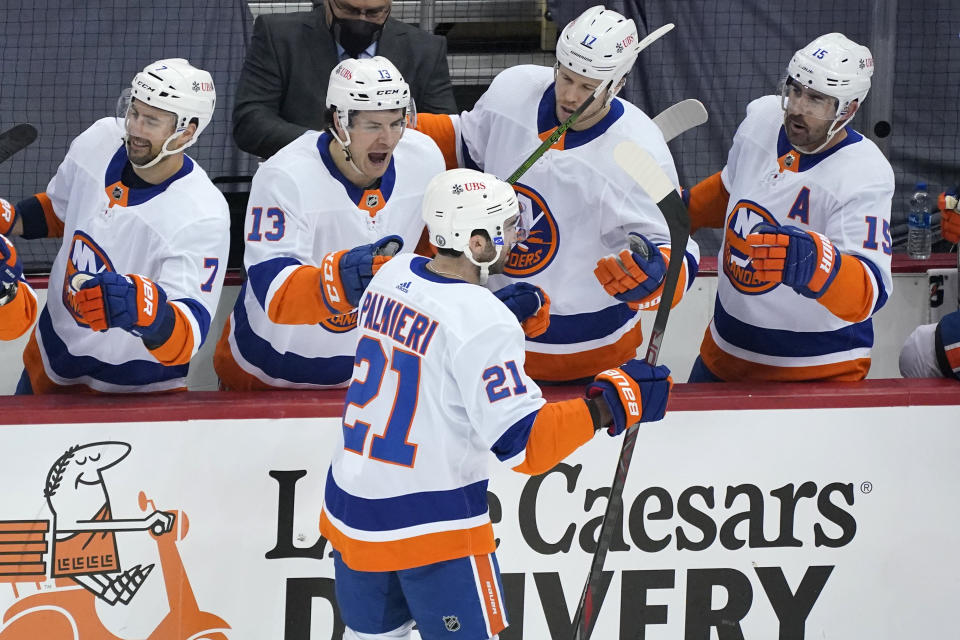 New York Islanders' Kyle Palmieri (21) returns to the bench after scoring during the first period in Game 1 of an NHL hockey Stanley Cup first-round playoff series against the Pittsburgh Penguins in Pittsburgh, Sunday, May 16, 2021. (AP Photo/Gene J. Puskar)