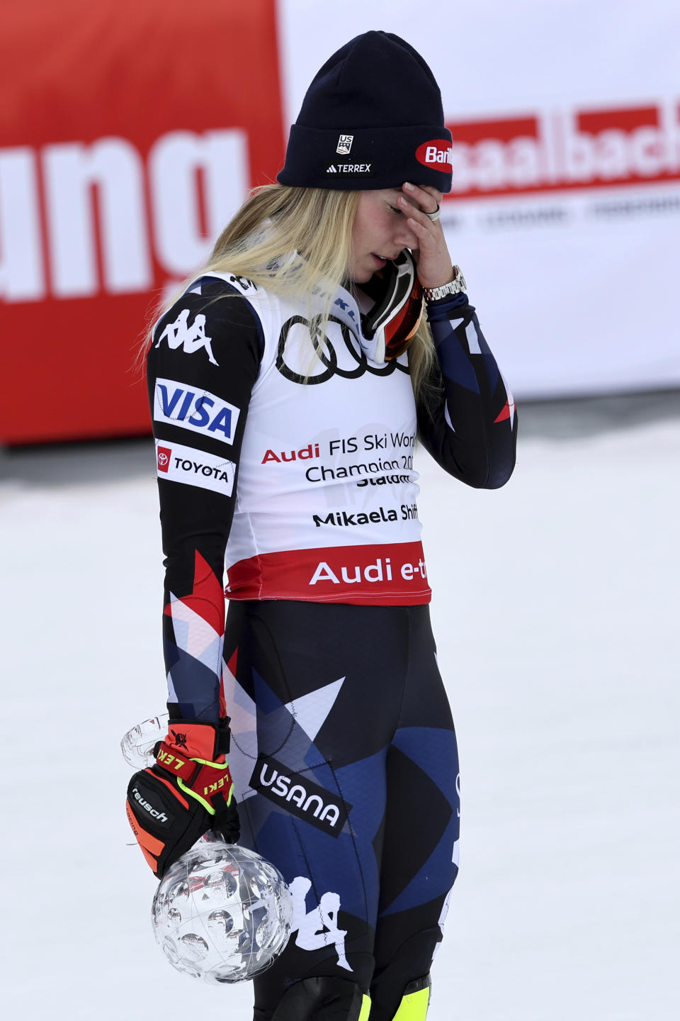 United States' Mikaela Shiffrin reacts as she holds the trophy for the alpine ski, women's World Cup slalom discipline, in Saalbach, Austria, Saturday, March 16, 2024. (AP Photo/Marco Trovati)
