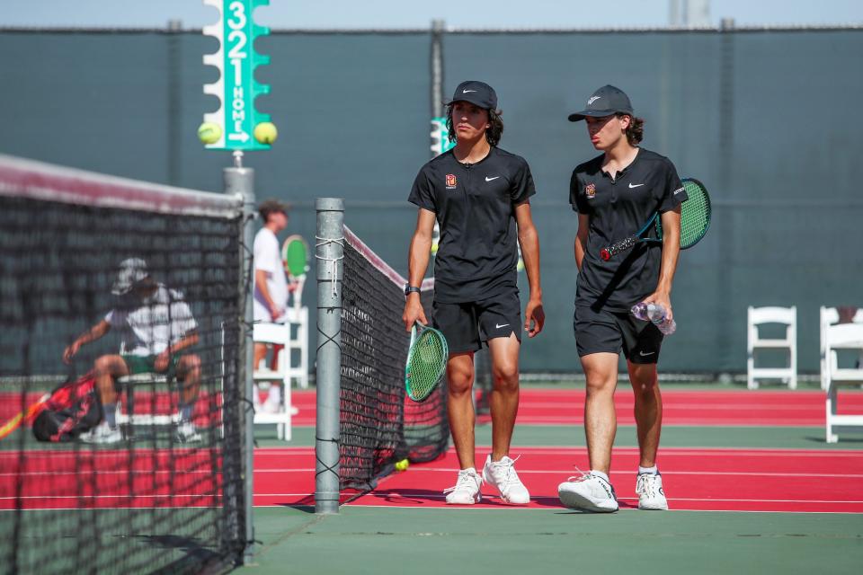 Ryan Vuilleumier, left, and twin brother Connor Vuilleumier of Palm Desert High walk off the court after their first-round CIF-SS Division 1 doubles match against Edison High in Palm Desert, Calif., on Wed., May 1, 2024.