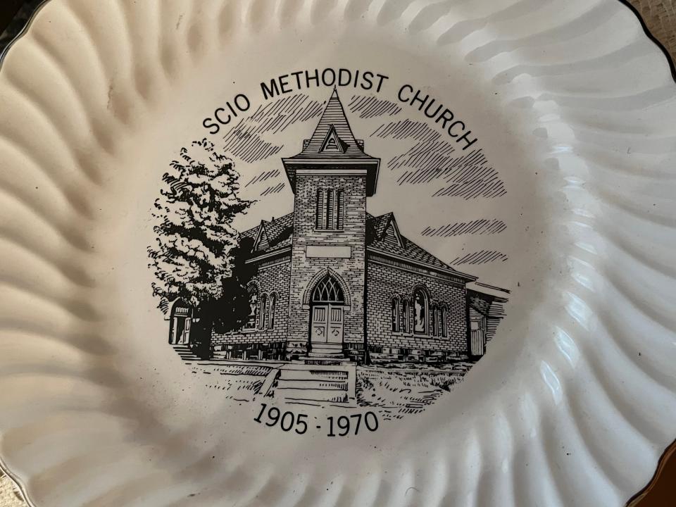 This commemorative plate shows the old building of the Scio United Methodist Church. The cornerstone of the building was laid in 1905 and services were held there beginning in 1907. The building burned in 1970.