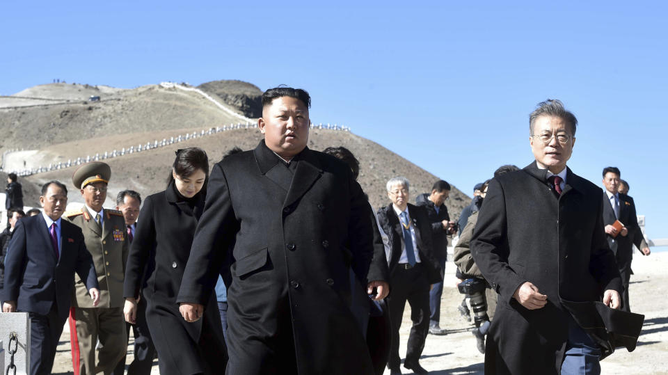 South Korean President Moon Jae-in, right, and North Korean leader Kim Jong Un, left, visit the Mount Paektu in North Korea, Thursday, Sept. 20, 2018. Moon and North Korean leader Kim Jong Un visited the picturesque and active volcano on the North Korean-Chinese border on Thursday and took a cable car to the crater lake called “Chonji" where they strolled together. (Pyongyang Press Corps Pool via AP)