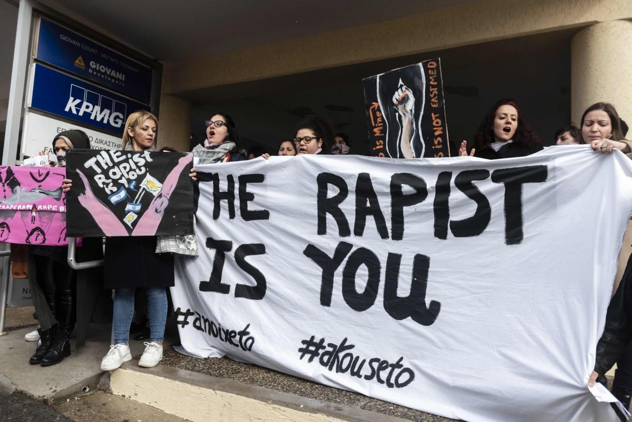 Activists outside court after a British woman was found guilty of faking a gang rape claim: AFP via Getty Images