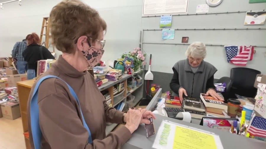 Karen Kropp sells books to a loyal customer at The Book Rack before closing up shop after over 40 years of operation on Feb. 27, 2024. (KTLA)