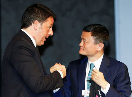 Italy's Prime Minister Matteo Renzi (L) greets Founder and Executive Chairman of Alibaba Group Jack Ma at the Vinitaly wine exhibition in Verona, Italy, April 11 2016. REUTERS/Stefano Rellandini