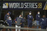 Tampa Bay Rays manager Kevin Cash, center with face mask down, watchers over a practice at Globe Life Field as the team prepares for the baseball World Series against the Los Angeles Dodgers, in Arlington, Texas, Wednesday, Oct. 14, 2020. (AP Photo/Eric Gay)