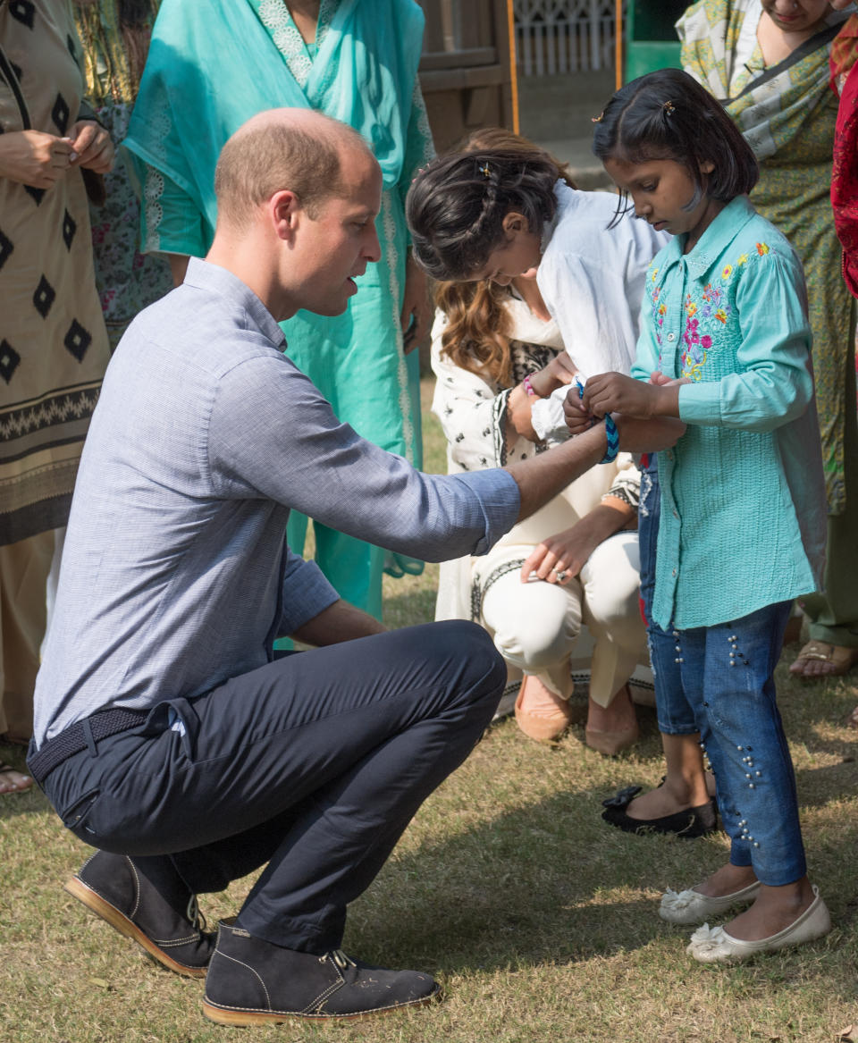 LAHORE, PAKISTAN - OCTOBER 18: Prince William, Duke of Cambridge is given a bracelet by children as he visits SOS Children’s Village, a charitable organisation in the heart of the city, on October 18, 2019 in Lahore, Pakistan. (Photo by Samir Hussein/WireImage)