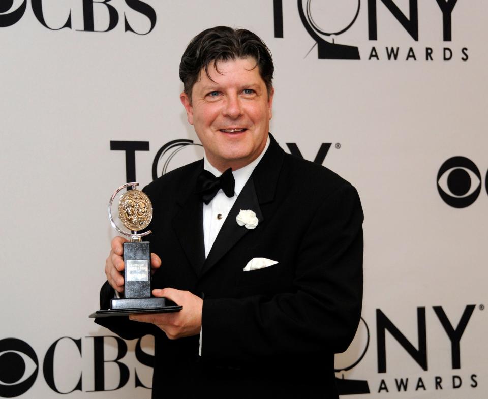 Michael McGrath poses with his award for best performance by an actor in a featured role in a musical at the 66th annual Tony Awards on Sunday June 10, 2012, in New York.
