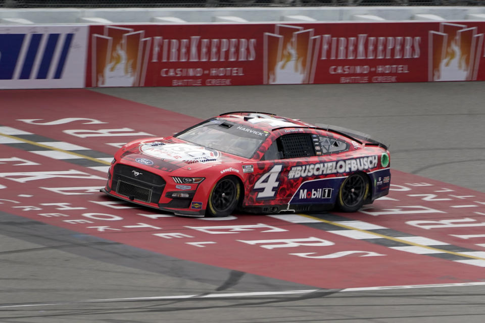 Kevin Harvick crosses the finish line to win the NASCAR Cup Series auto race at the Michigan International Speedway in Brooklyn, Mich., Sunday, Aug. 7, 2022. (AP Photo/Paul Sancya)