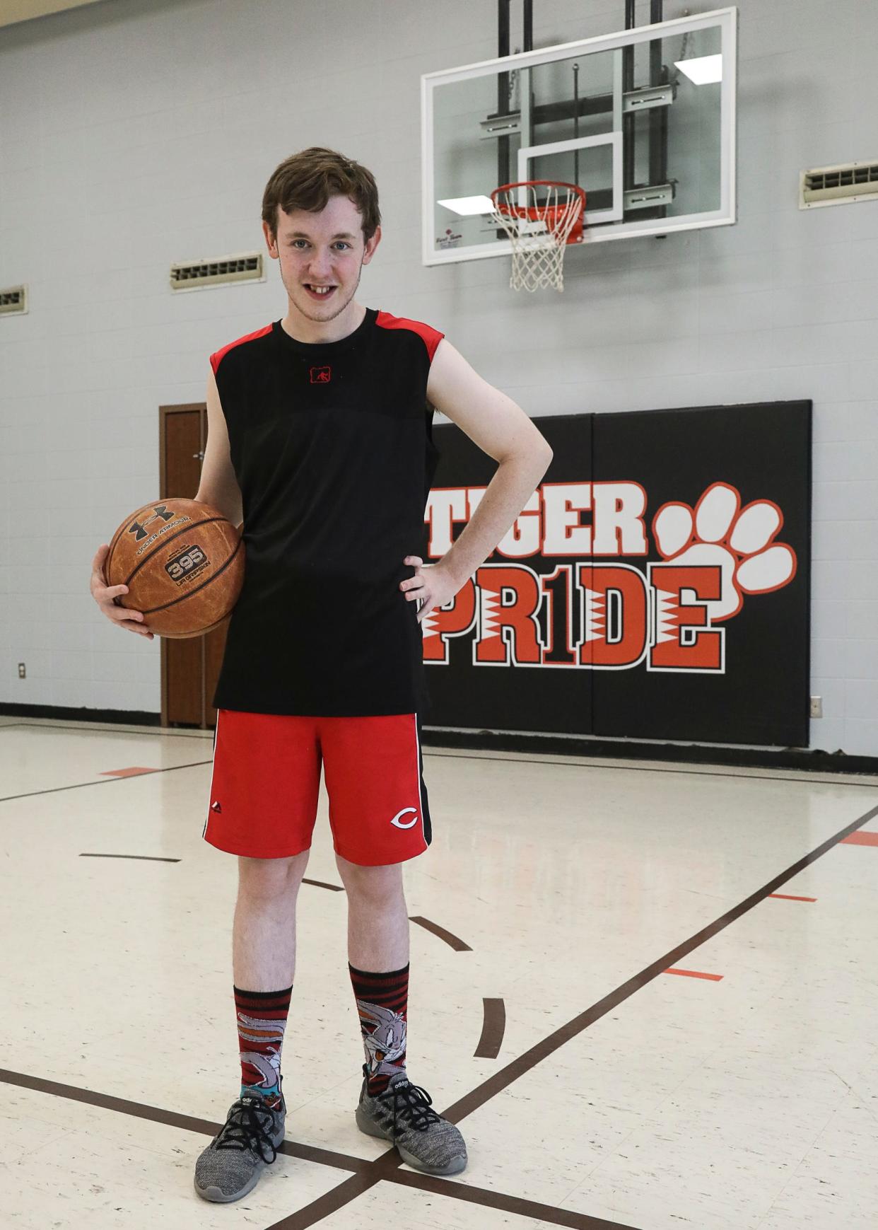 Pioneer senior Jacob Delozier has battled through autism, cerebral palsy, and attention-deficit/hyperactivity disorder to pursue his interests in athletics like basketball and running.