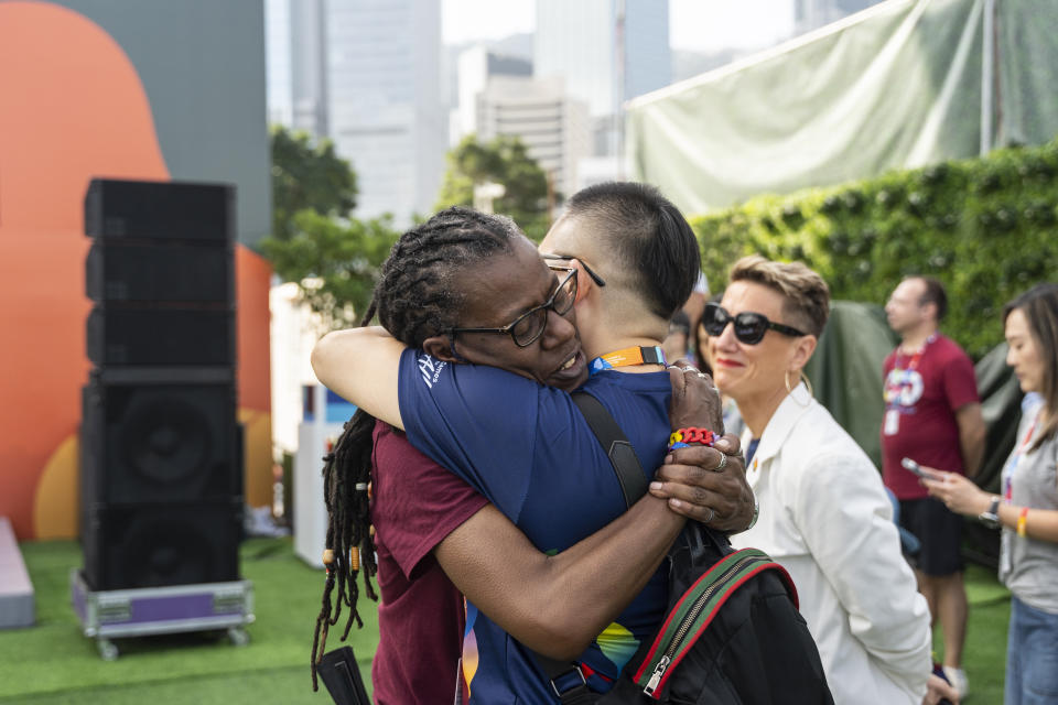 Participants react during the AIDS Quilt Memorial Ceremony, ahead of the Gay Games in Hong Kong, Saturday, Nov. 4, 2023. The first Gay Games in Asia are fostering hopes for wider LGBTQ+ inclusion in the regional financial hub, following recent court wins in favor of equality for same-sex couples and transgender people. (AP Photo/Chan Long Hei)