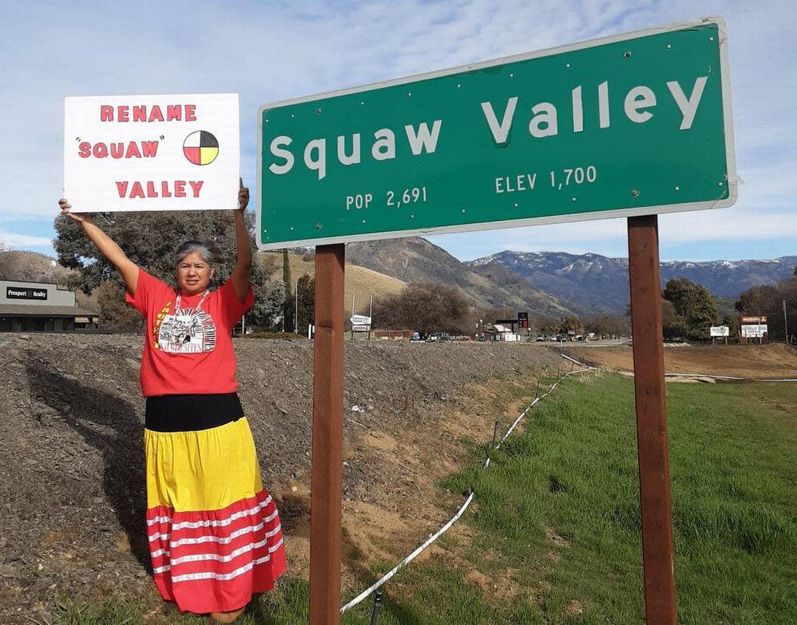 Taweah Garcia holds a sign supporting a campaign to change the name of Squaw Valley in Fresno County, California. Her sign includes a Native American symbol representing the four directions and people from all nations, she said.